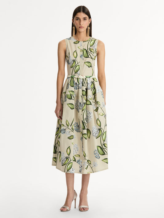 Porcelain Flower Cotton Poplin Dress This cotton poplin dress. Clean, sculpted lines. Relaxed, mid-length silhouette. with cinching matching self-belt at the waist. Front View.