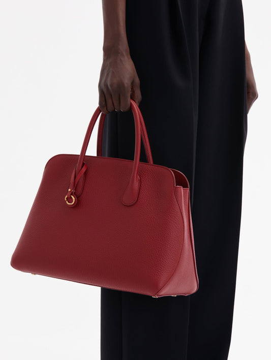 The Ivy bag in Scarlet, front view with shoulder strap showing and Oscar O logo around the Top handle.