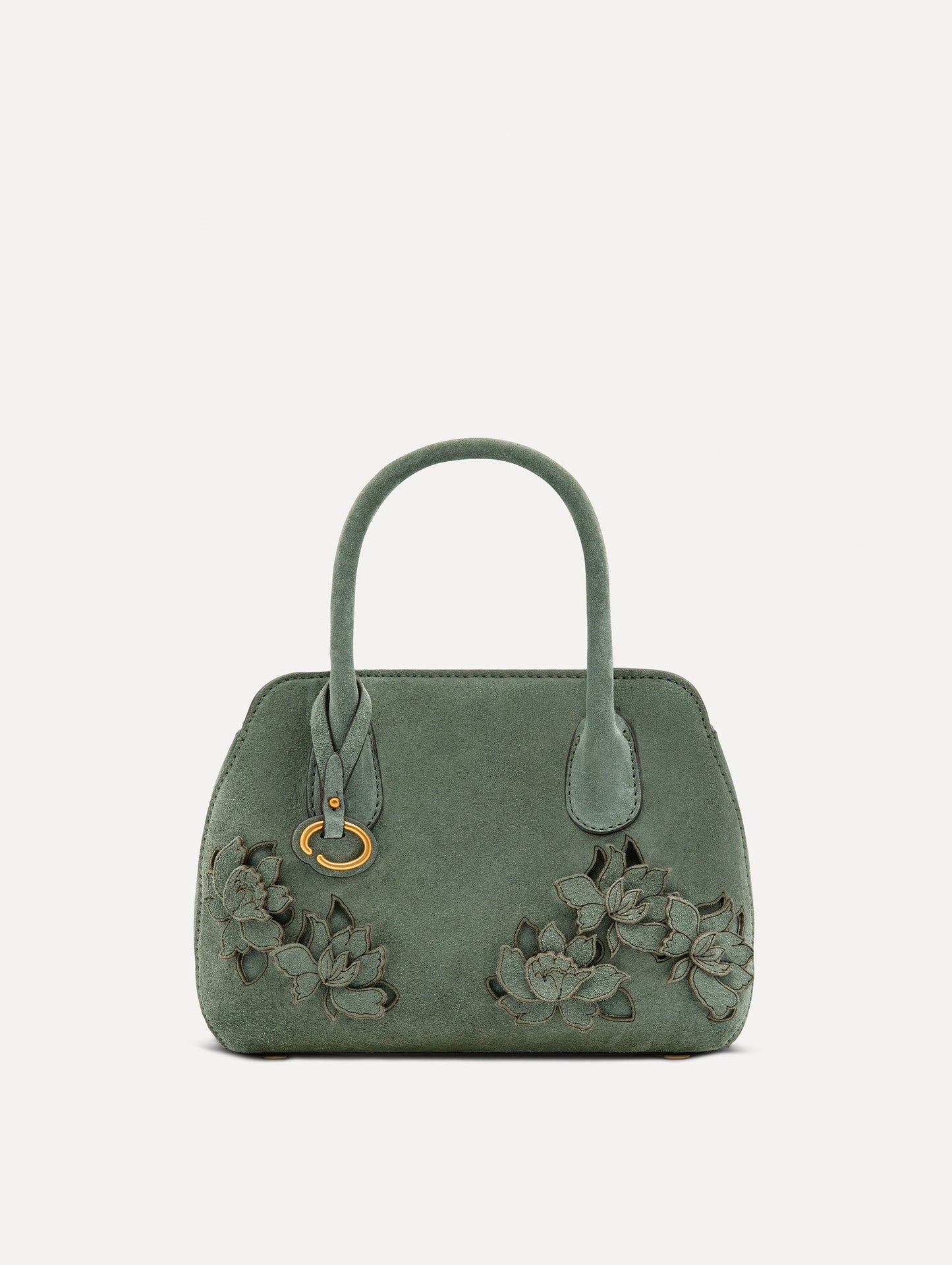 Front view of The Mini Ivy With Laser Cut Flowers in sage which has a compartment with top handles and various Oscar 'O' emblems on the hangtag and magnetic closure.