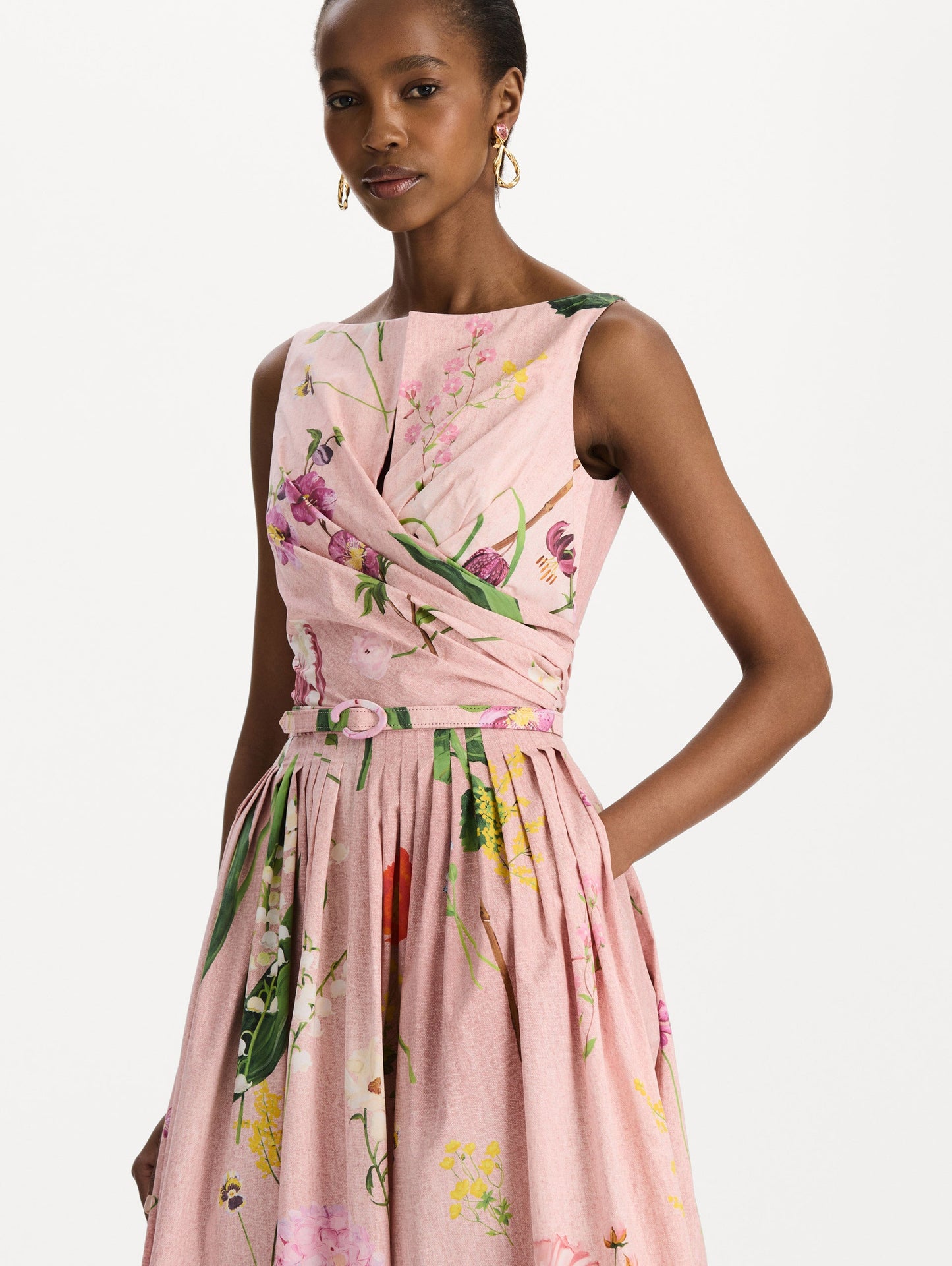 The model is wearing the mixed botanical cotton poplin draped dress with waist detailing and an all-over floral print in blush multi. Zoom view.