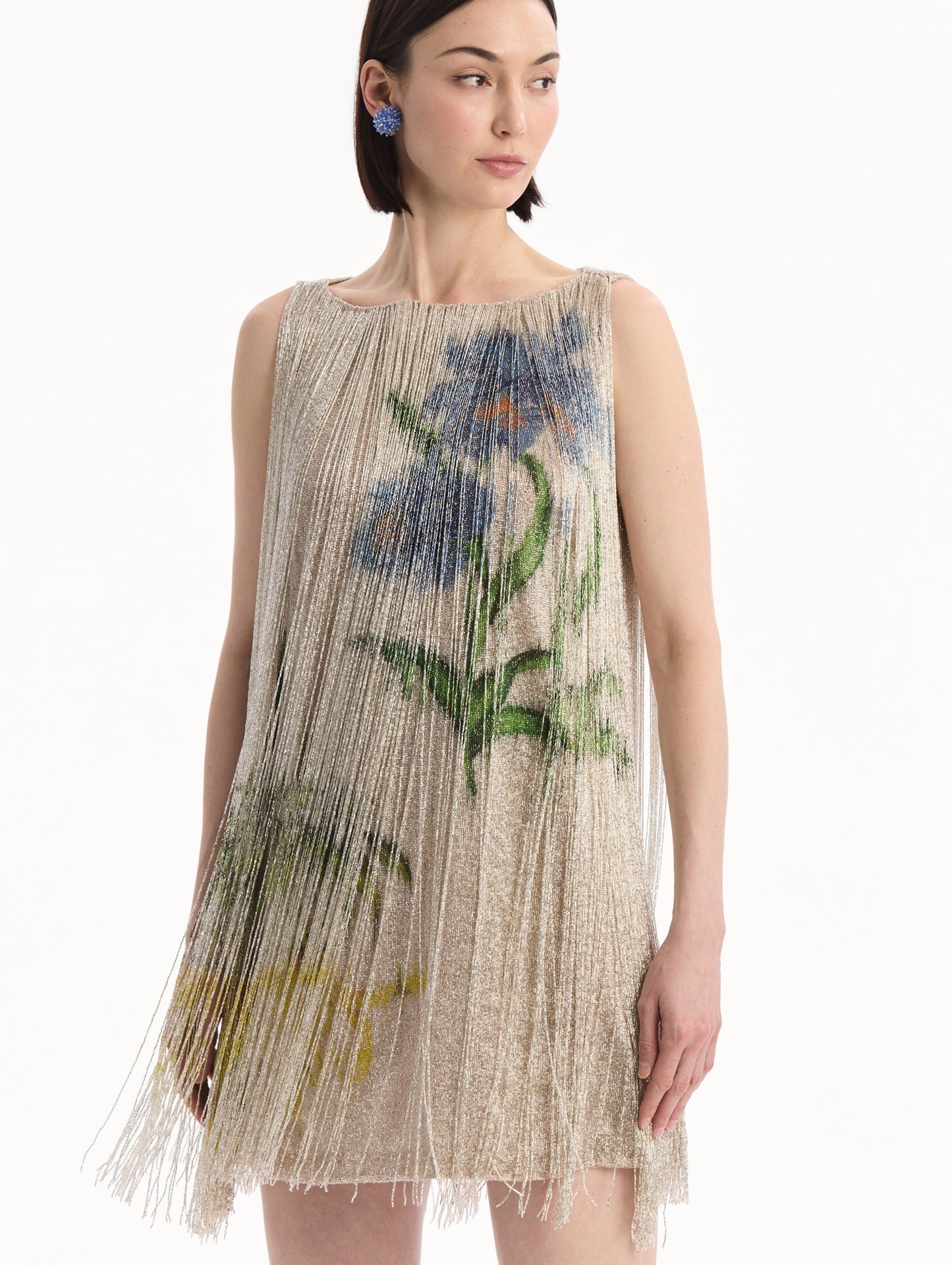 The model is wearing the Chiné Hibiscus Beaded Fringe Shift Dress. Featuring layers of beaded fringe and mini length. Detail View.