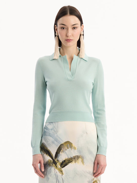 The model is wearing the Wool Polo Pullover in Saltwater Blue. Featuring an open color neckline, long sleeves, and ribbed trim. Front View.