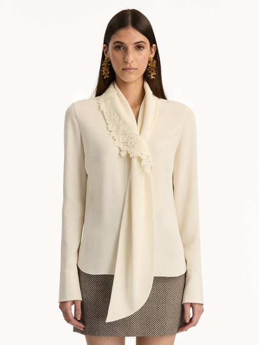 Ivory Foxglove Tie-Neck Georgette Blouse featuring a floral applique and long sleeves. Front View.