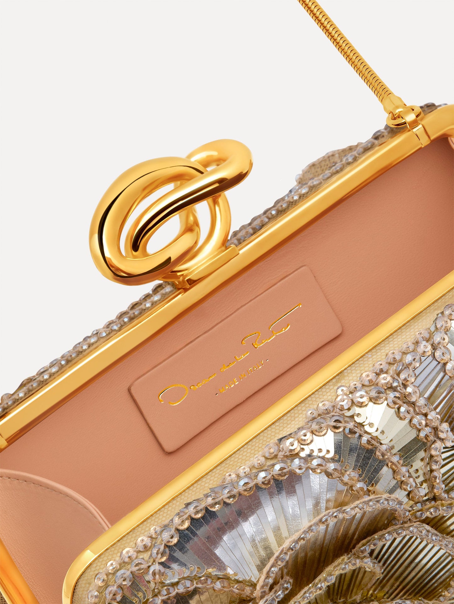 Silver Crystal Pavé Knot Minaudière with gold hardware and an O motif clasp. Zoom View.