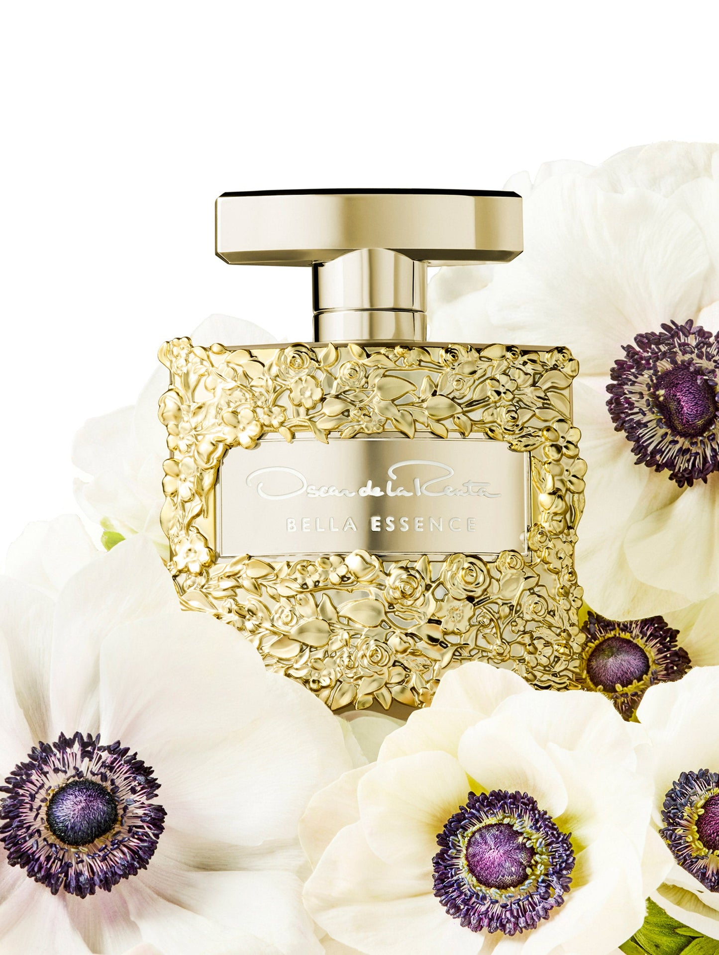 Oscar Gold Rose Texture Bella Essence Perfume Bottle with Flowers Surrounding the Bottle. Front View