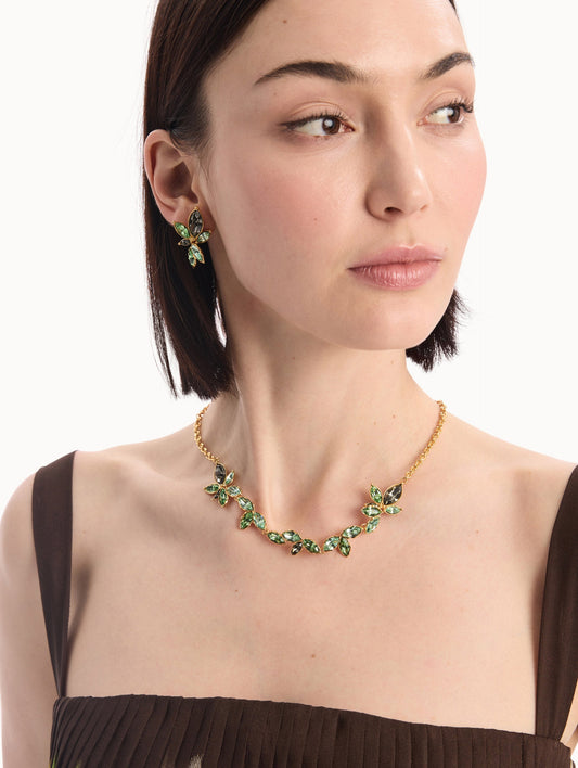 The model is wearing the Navette Crystal Necklace in Peridot. Front View.