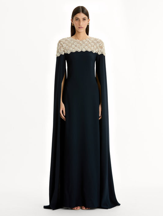 Navy Embroidered Caftan with ivory embroidered neckline and floor-length draped silhouette. Front View.