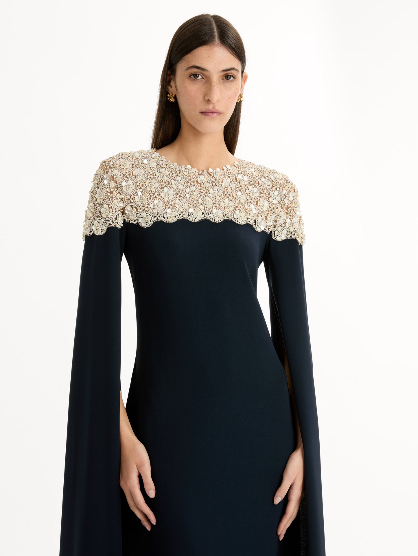 Navy Embroidered Caftan with ivory embroidered neckline and floor-length draped silhouette. Zoom View.