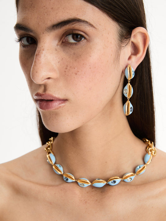 Blue Enamel Cowrie Shell Necklace with blue and gold enamel shells with blue and clear crystals. Front view.
