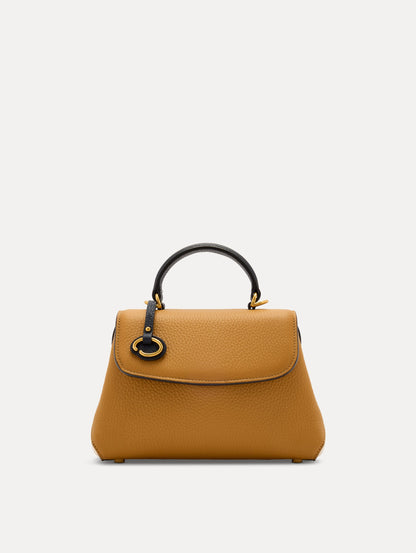 The Mini Poppy Handbag in Honey with Black Top Handle. Adorned with Oscar de la Renta's signature O at the ornamental bag tag. Front View