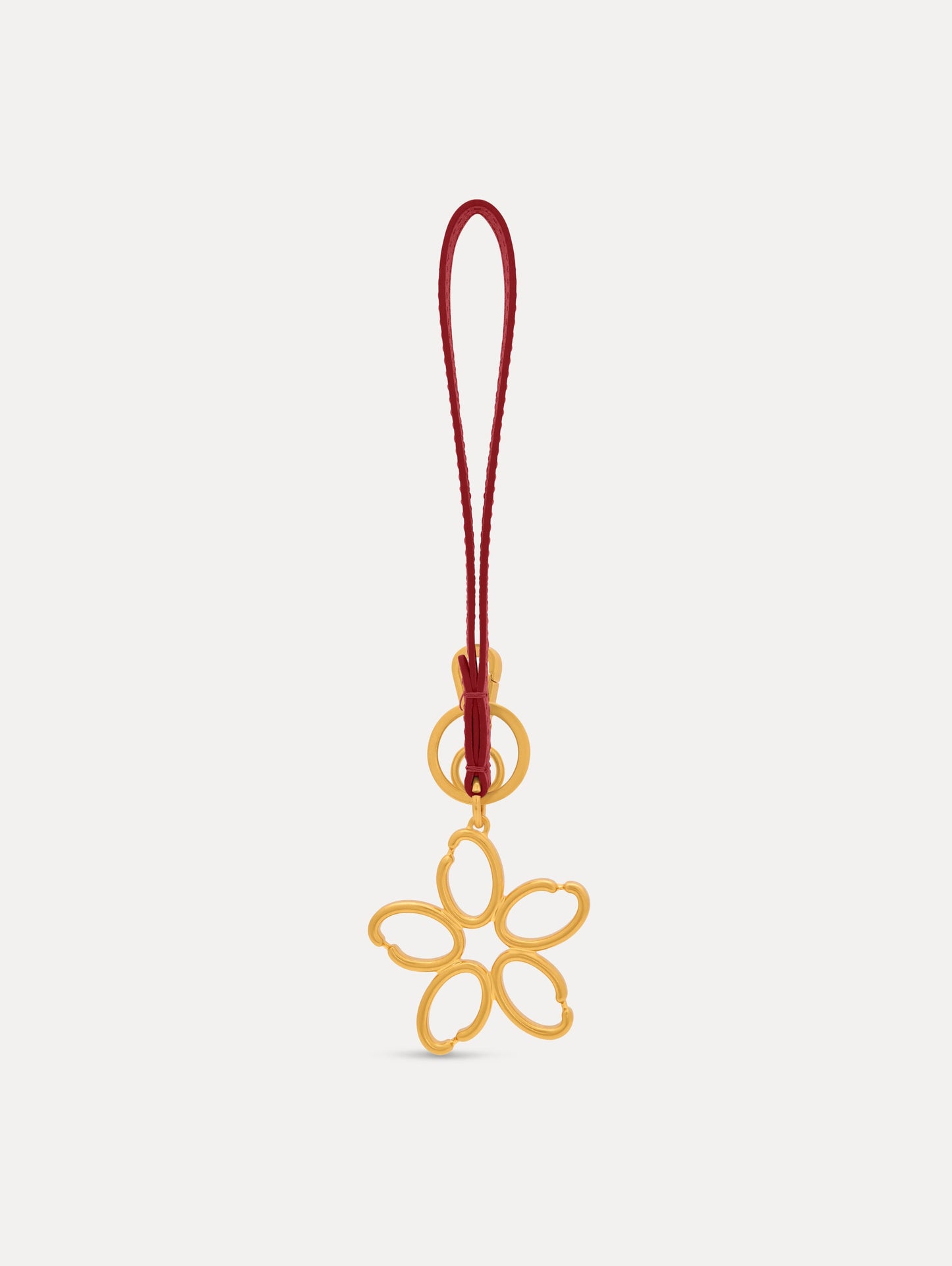 Gold O Flower Wristlet Key Chain with a five-petal open flower that hangs from a deep red leather loop strap, connected by a small gold ring and clasp. Front View.