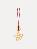 Gold O Flower Wristlet Key Chain with a five-petal open flower that hangs from a deep red leather loop strap, connected by a small gold ring and clasp. Front View.