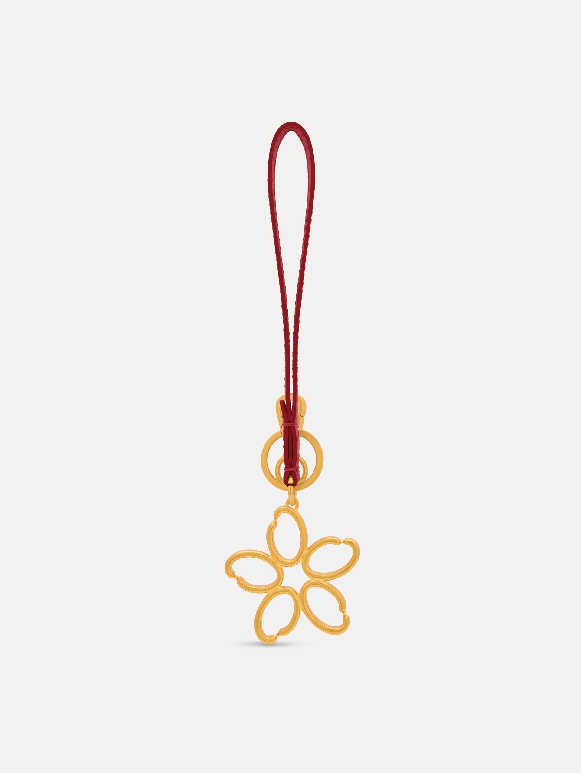 Gold O Flower Wristlet Key Chain with a five-petal open flower that hangs from a deep red leather loop strap, connected by a small gold ring and clasp. Front View.