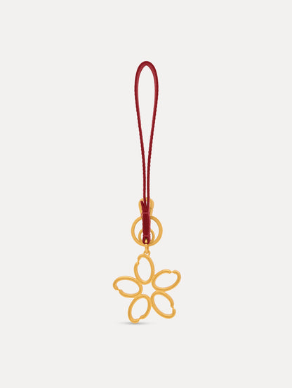 Gold O Flower Wristlet Key Chain with a five-petal open flower that hangs from a deep red leather loop strap, connected by a small gold ring and clasp. Front View.