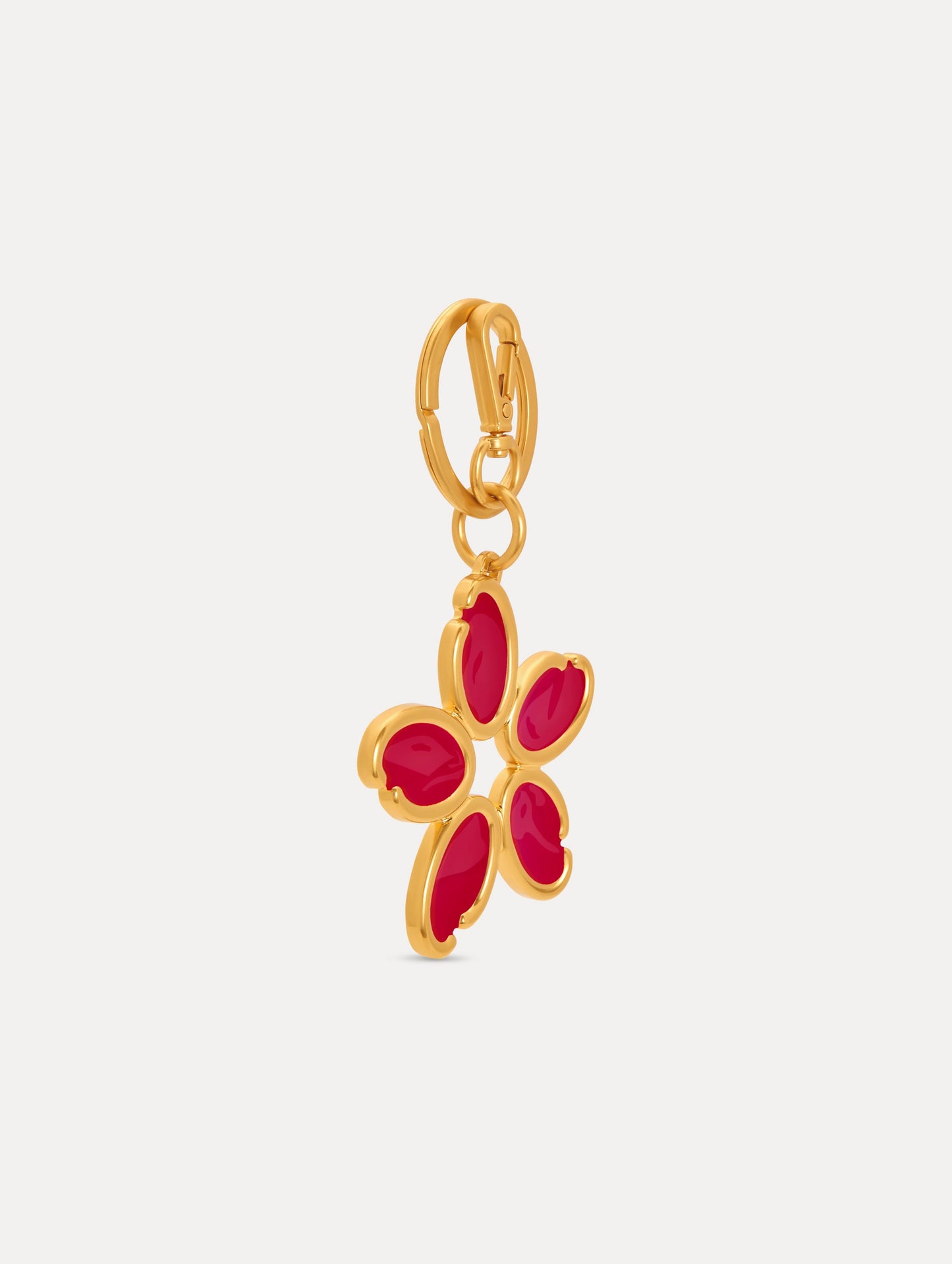Gold Enamel O Flower Key Chain featuring a five-petal flower charm with smooth, red inlays framed by rounded gold edges, attached to a circular clasp. Side View.
