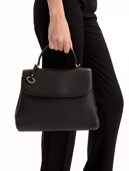 The Poppy Leather Handbag in Black with O logo Tag around the Top Handle, and Detachable Shoulder Strap. Front View.