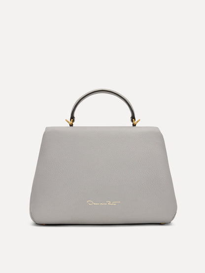 The Poppy Leather Handbag in Grey with O logo Tag around the Top Handle, and Detachable Shoulder Strap. Back View