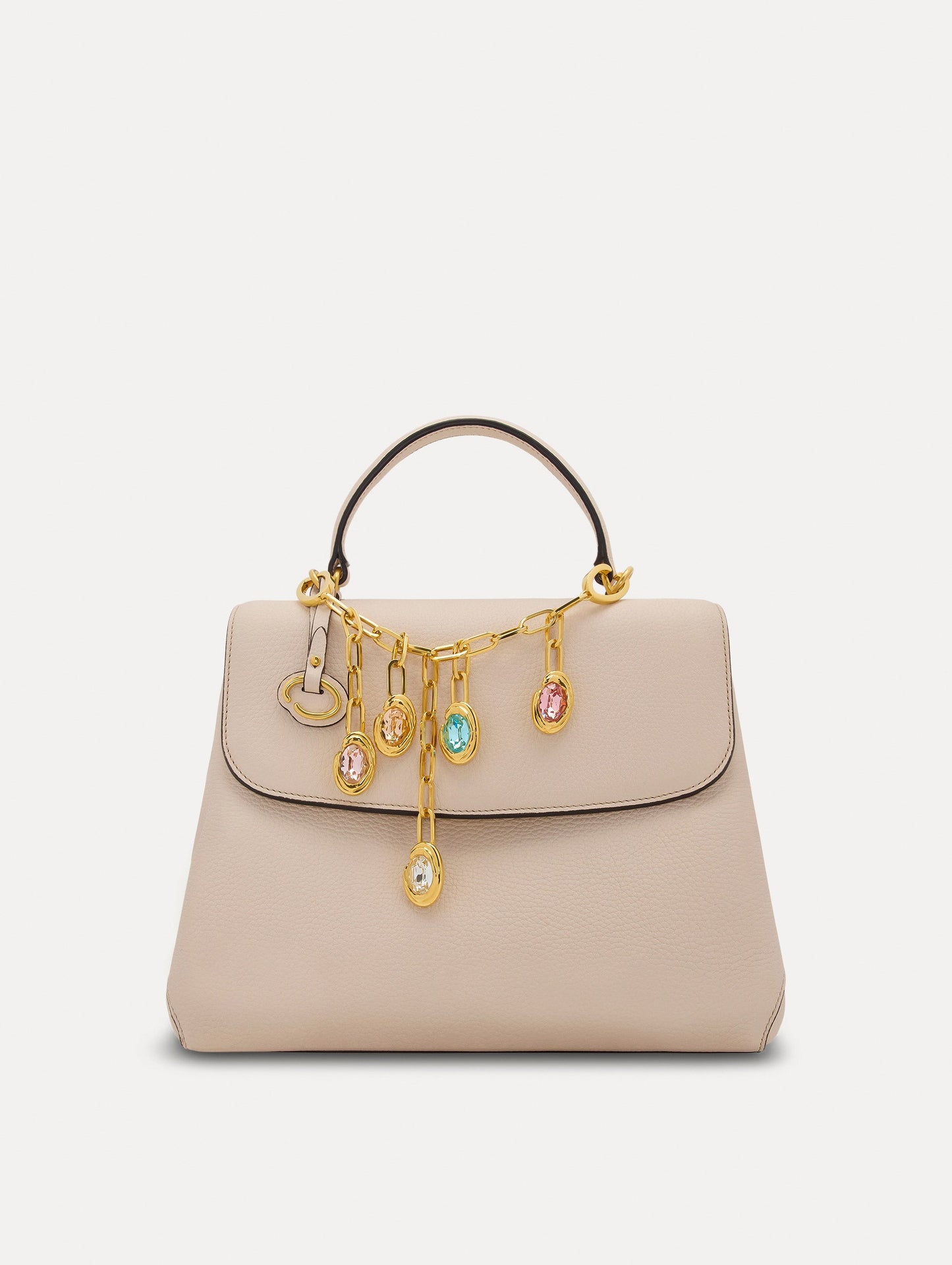 Pink, Orange, and Blue Crystals O Bag Charm in Gold styled with an ivory mini top handle handbag. Front View
