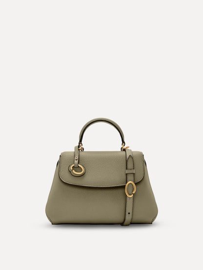 The Mini Poppy top handle bag in green. Front view.