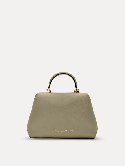 The Mini Poppy top handle bag in green. Back view.
