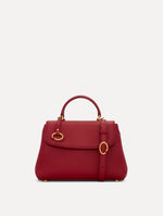 The Mini Poppy Leather Handbag in Red with O tag around the Top handle and Detachable Shoulder Strap Front View
