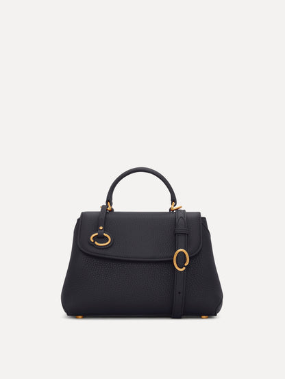 Mini Poppy in a light dark navy. The Mini Poppy is a top handle bag with a detachable shoulder strap, and it has the Oscar O logo attached around the top handle. Front View.