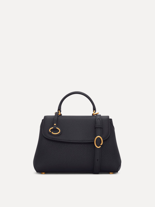 Mini Poppy in a light dark navy. The Mini Poppy is a top handle bag with a detachable shoulder strap, and it has the Oscar O logo attached around the top handle. Front View.