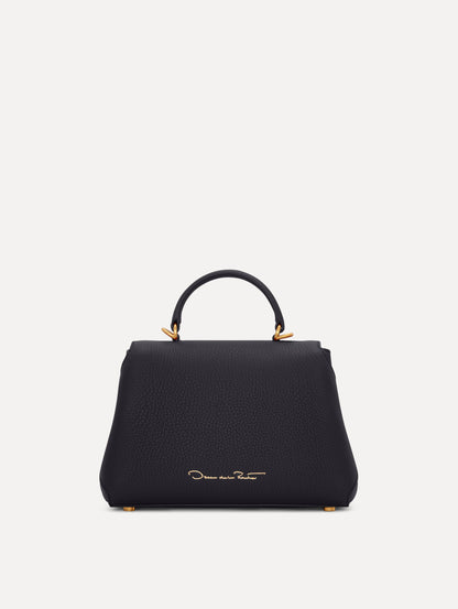 Mini Poppy in a light dark navy. The Mini Poppy is a top handle bag with a detachable shoulder strap, and it has the Oscar O logo attached around the top handle. Back View.