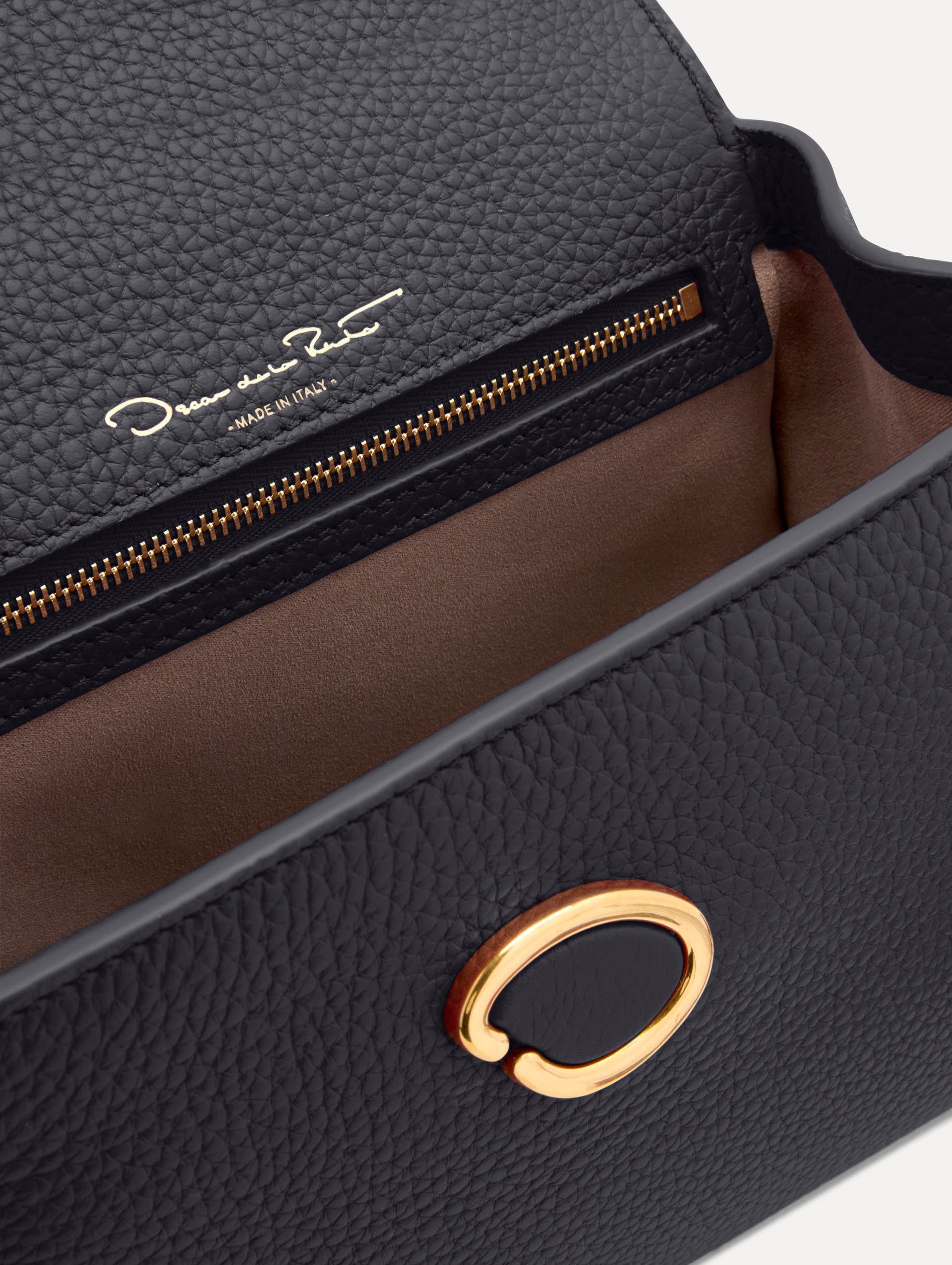 Mini Poppy in a light dark navy. The Mini Poppy is a top handle bag with a detachable shoulder strap, and it has the Oscar O logo attached around the top handle. Zoom View.