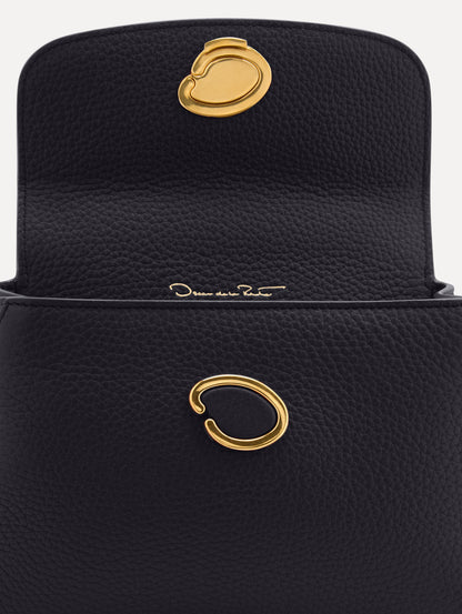 Mini Poppy in a light dark navy. The Mini Poppy is a top handle bag with a detachable shoulder strap, and it has the Oscar O logo attached around the top handle. Zoom View.