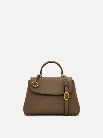 The Mini Poppy Leather Handbag in Stone with O tag around the Top handle and Detachable Shoulder Strap Front View