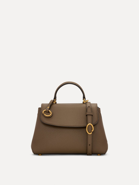 The Mini Poppy Leather Handbag in Stone with O tag around the Top handle and Detachable Shoulder Strap Front View