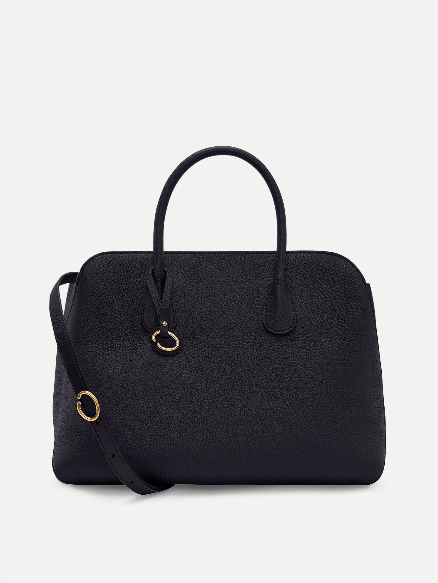 The Ivy top handle handbag in black, paired with some khaki pants. The bag comes with the Oscar O logo as a tag around the handle. Front View.