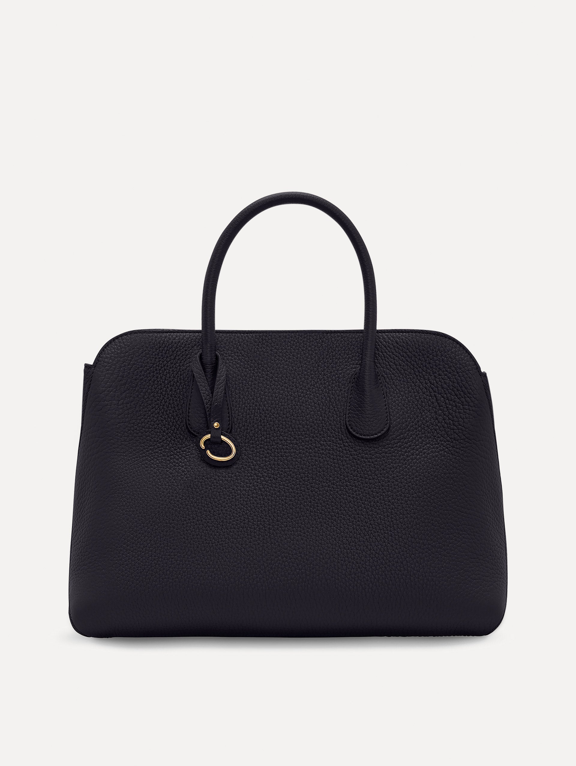 The Ivy top handle handbag in black, paired with some khaki pants. The bag comes with the Oscar O logo as a tag around the handle. Front View.