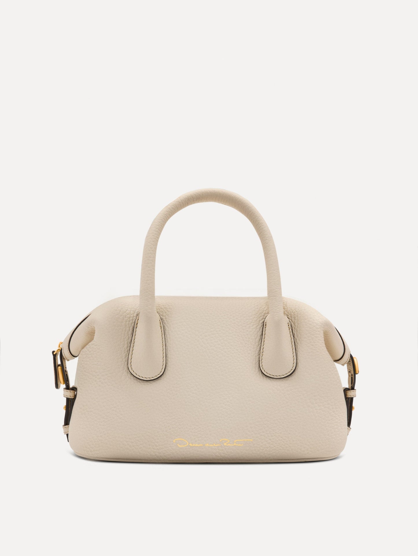 The Mini Dahlia leather handbag in ivory, with O logo tag around the top handle and a Gold Heart bag charm on the other side. Back View