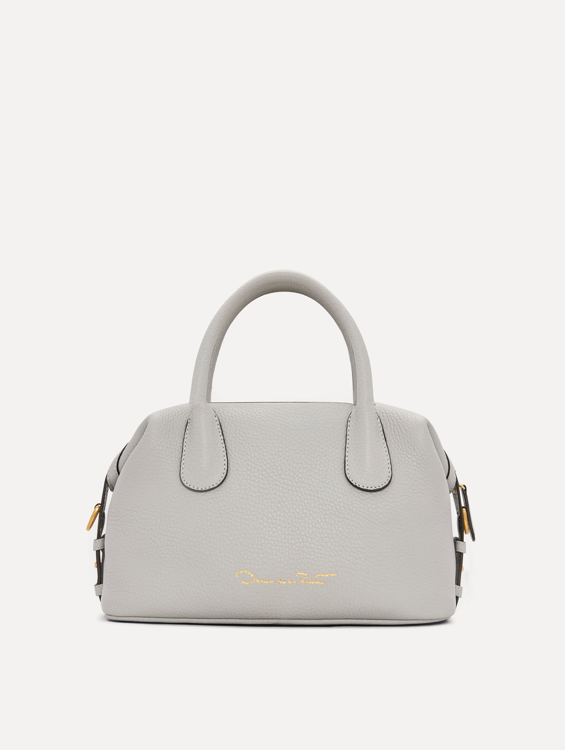 The Mini Dahlia Leather Handbag in Pearl Grey with Detachable Shoulder Strap and O logo tag around the Top Handle. Back View