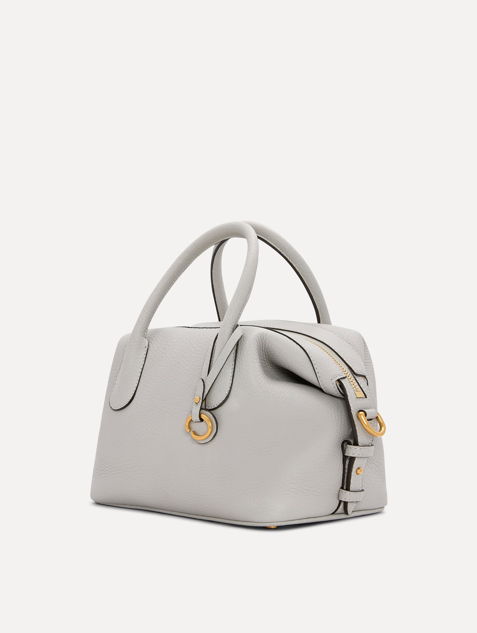 The Mini Dahlia Leather Handbag in Pearl Grey with Detachable Shoulder Strap and O logo tag around the Top Handle. Side View