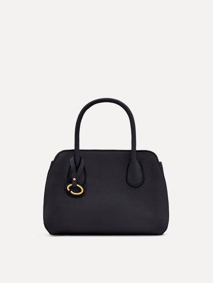 Mini Ivy in a light dark navy. The Mini Ivy is a top handle bag with a detachable shoulder strap, and it has the Oscar O logo attached around the top handle. Front View.