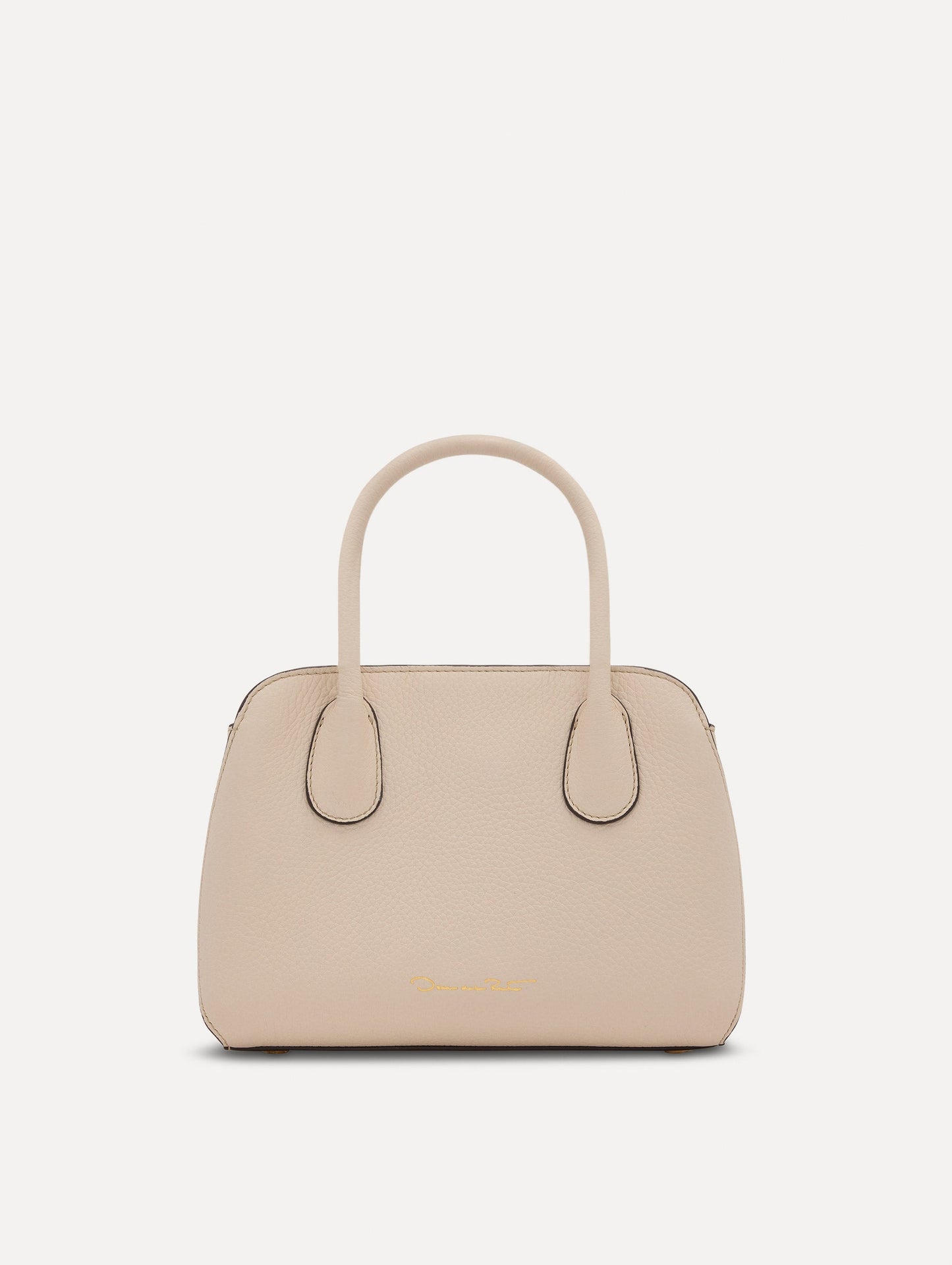 The Mini Ivy top handle handbag in Ivory. This bag comes with a detachable shoulder strap and has an Oscar O logo tag around the handle. Back View.