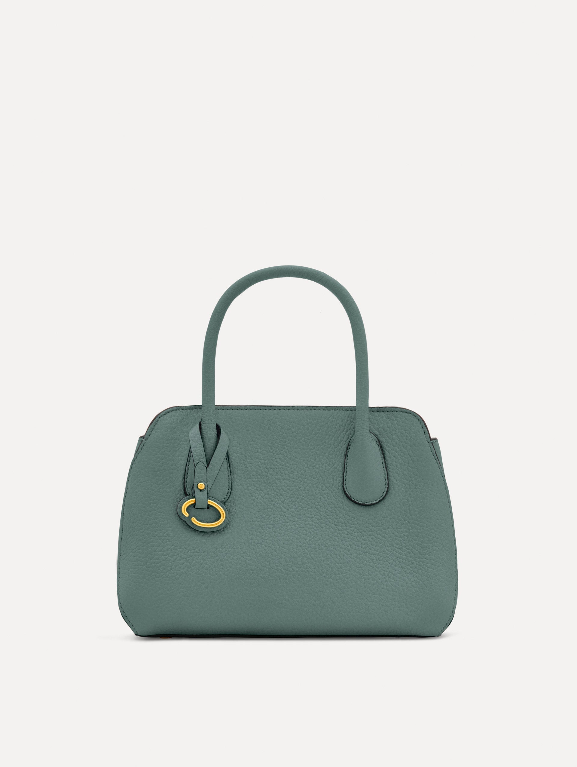 Mini Ivy in a light mint color. The Mini Ivy is a top handle bag with a detachable shoulder strap, and it has the Oscar O logo attached around the top handle. Front View.