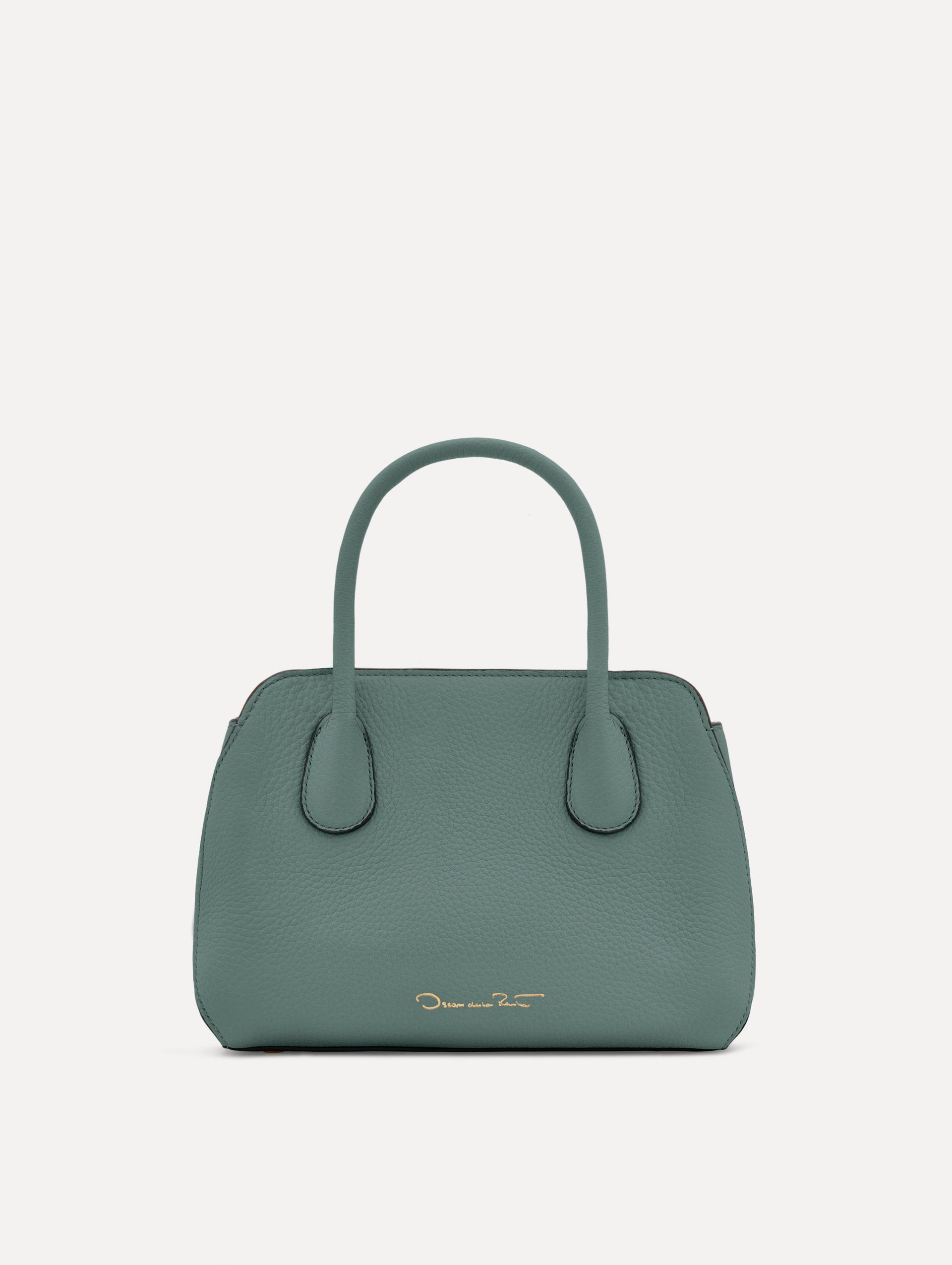 Mini Ivy in a light mint color. The Mini Ivy is a top handle bag with a detachable shoulder strap, and it has the Oscar O logo attached around the top handle. Back View.