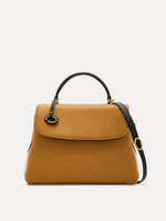 The Poppy Handbag in Honey with Black Top Handle and removeable shoulder strap. Adorned with Oscar de la Renta's signature O at the ornamental bag tag. Front View