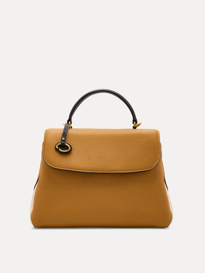 The Poppy Handbag in Honey with Black Top Handle. Adorned with Oscar de la Renta's signature O at the ornamental bag tag. Front View