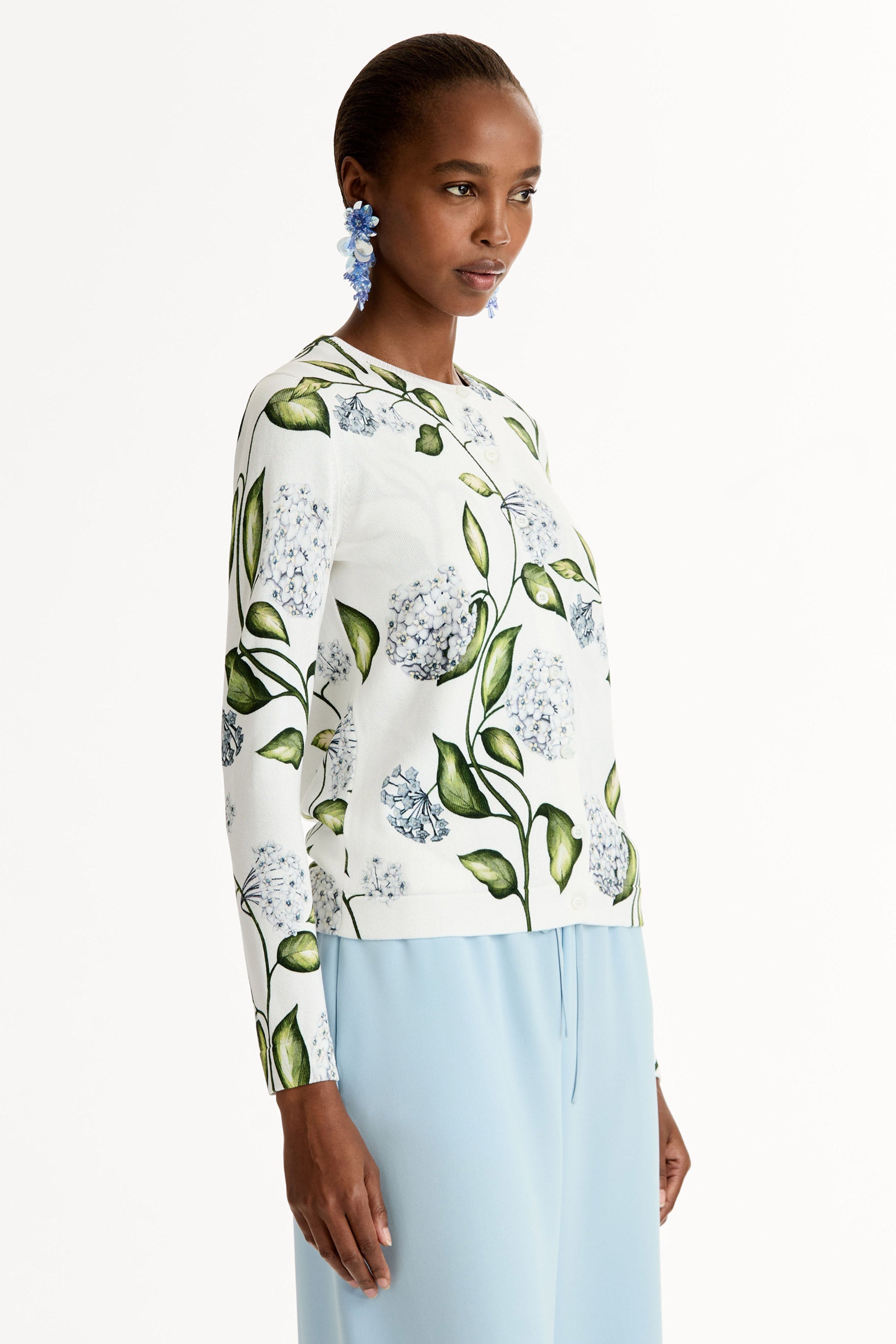 Classic ribbed-knit long sleeve cardigan with Porcelain motif.Crew neckline and banded trim. Side View.