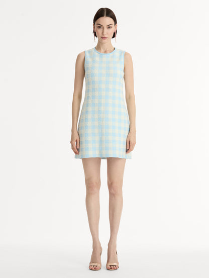 Sleeveless, texture jacquard, halter neck mini dress in Classic gingham pattern in pale blue and ivory. Front View.