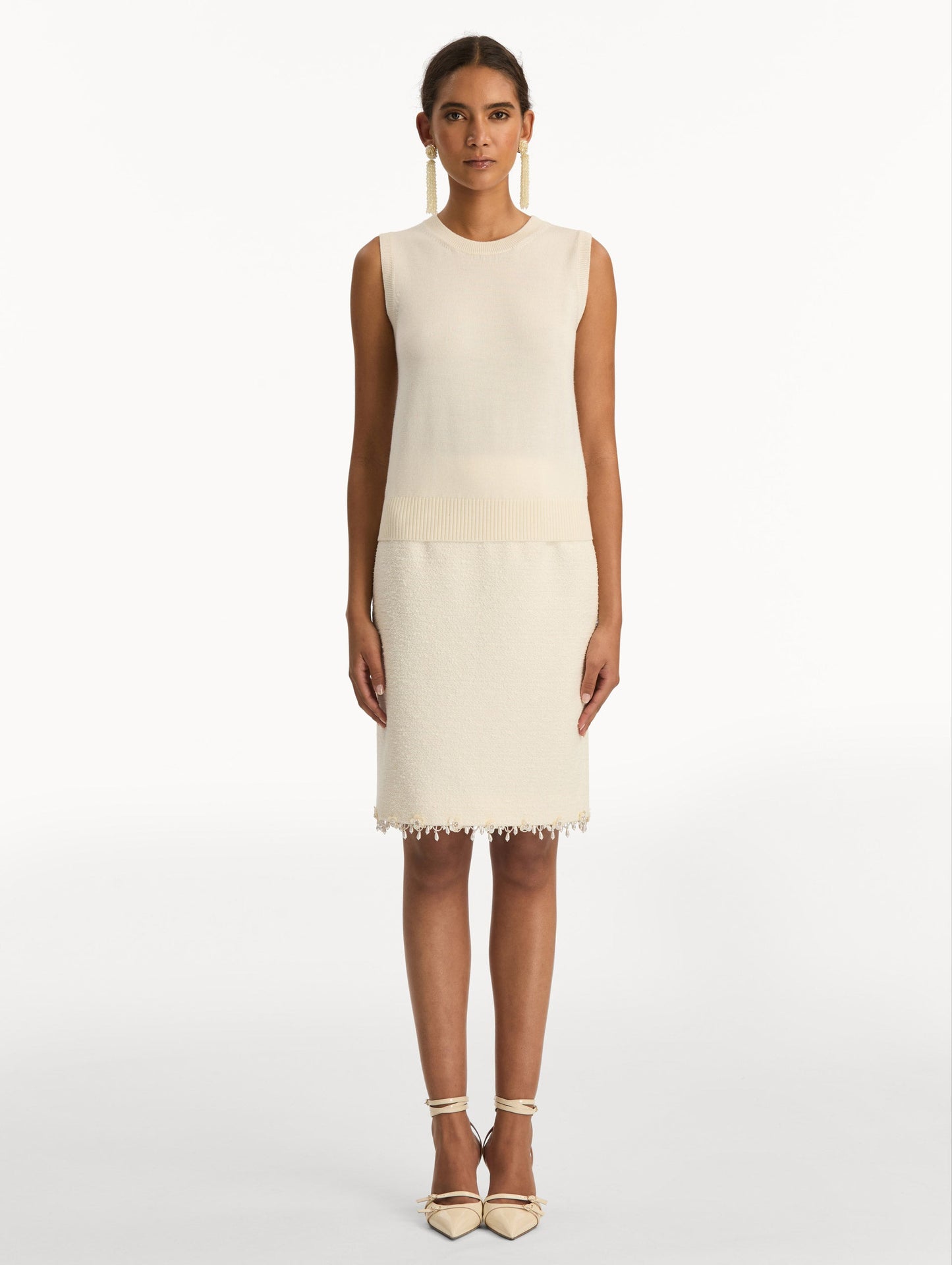 Ivory Virgin Wool Tank featuring a crew neckline and ribbed hem. Front View.
