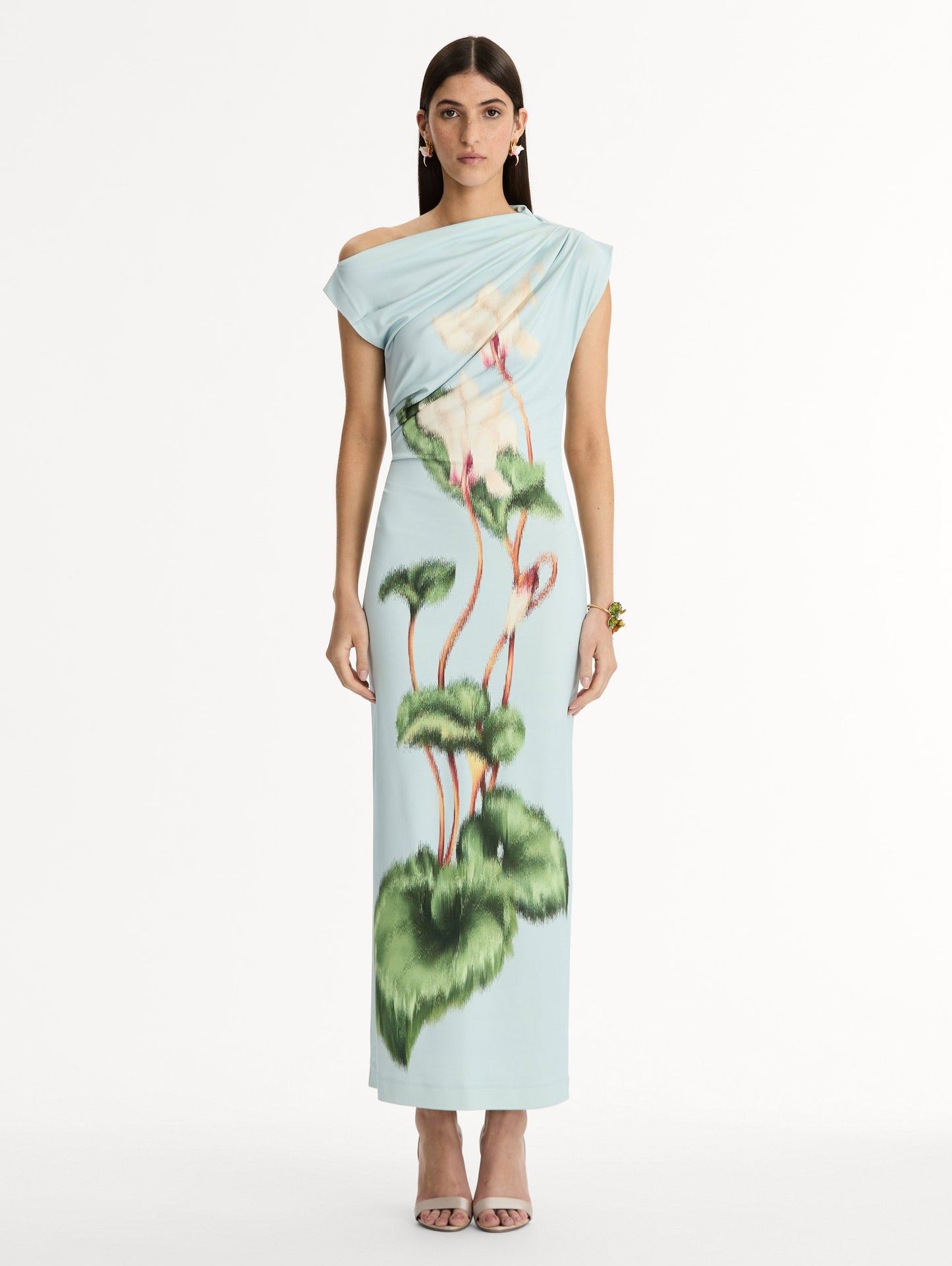 Light blue, ankle length jersey dress. Chiné Cyclamen motif with blurred edges. Asymmetric neckline, off the shoulder. Front view.