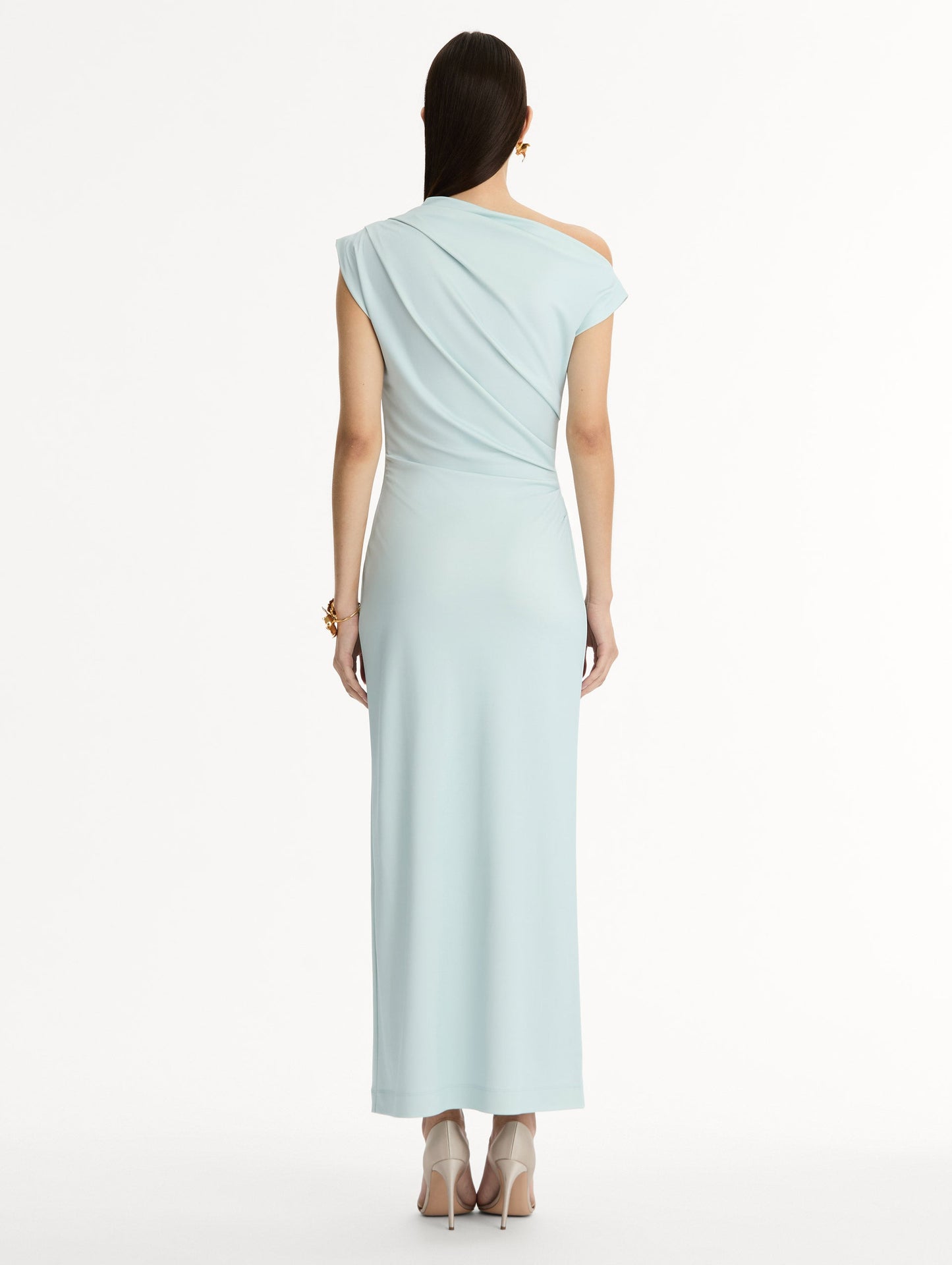 Light blue, ankle length jersey dress. Chiné Cyclamen motif with blurred edges. Asymmetric neckline, off the shoulder. Back view.