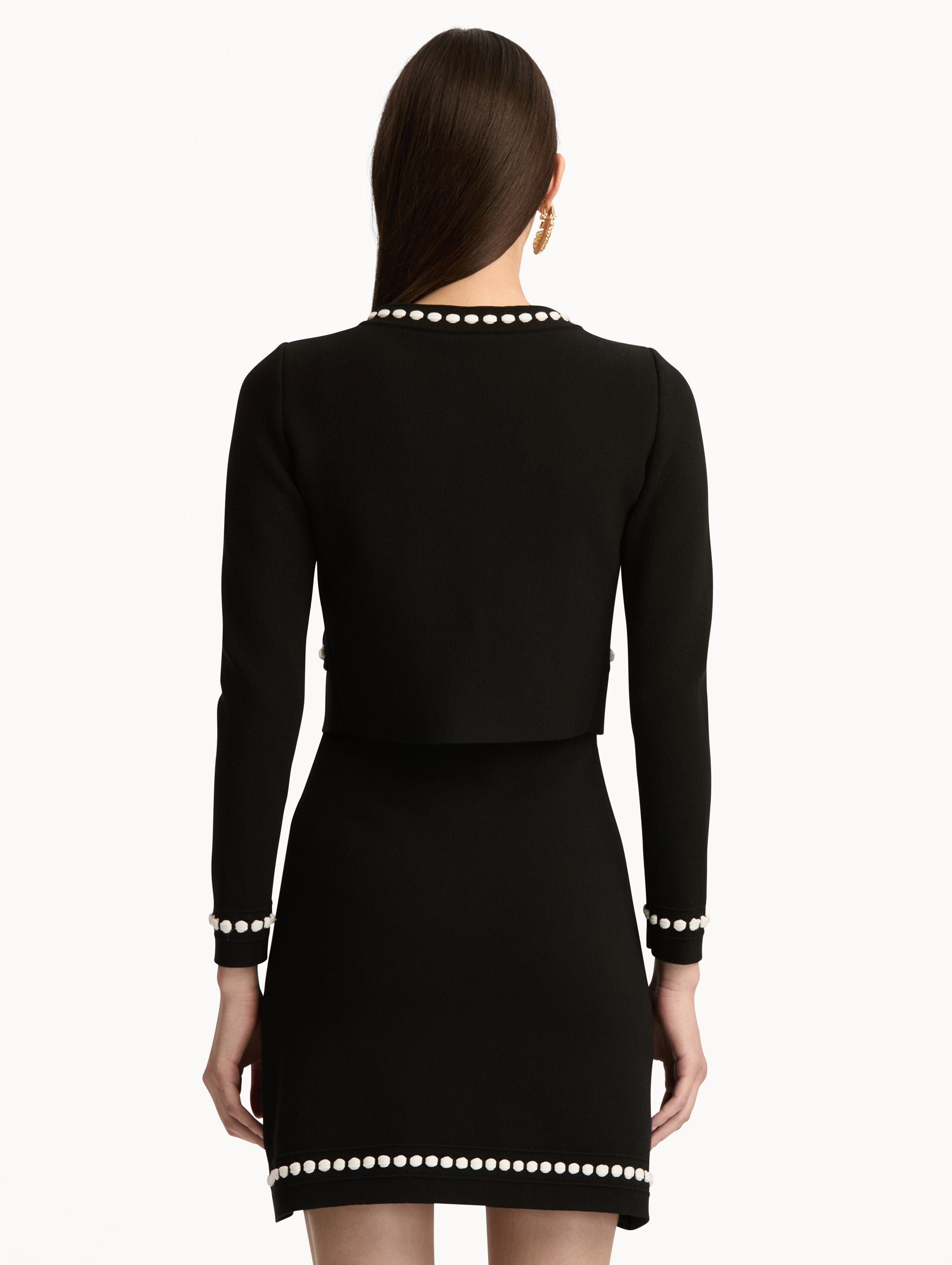 Black and White Bubble Trim Cardigan featuring white beaded trim, long sleeves, and a tie-neck collar. Back View.