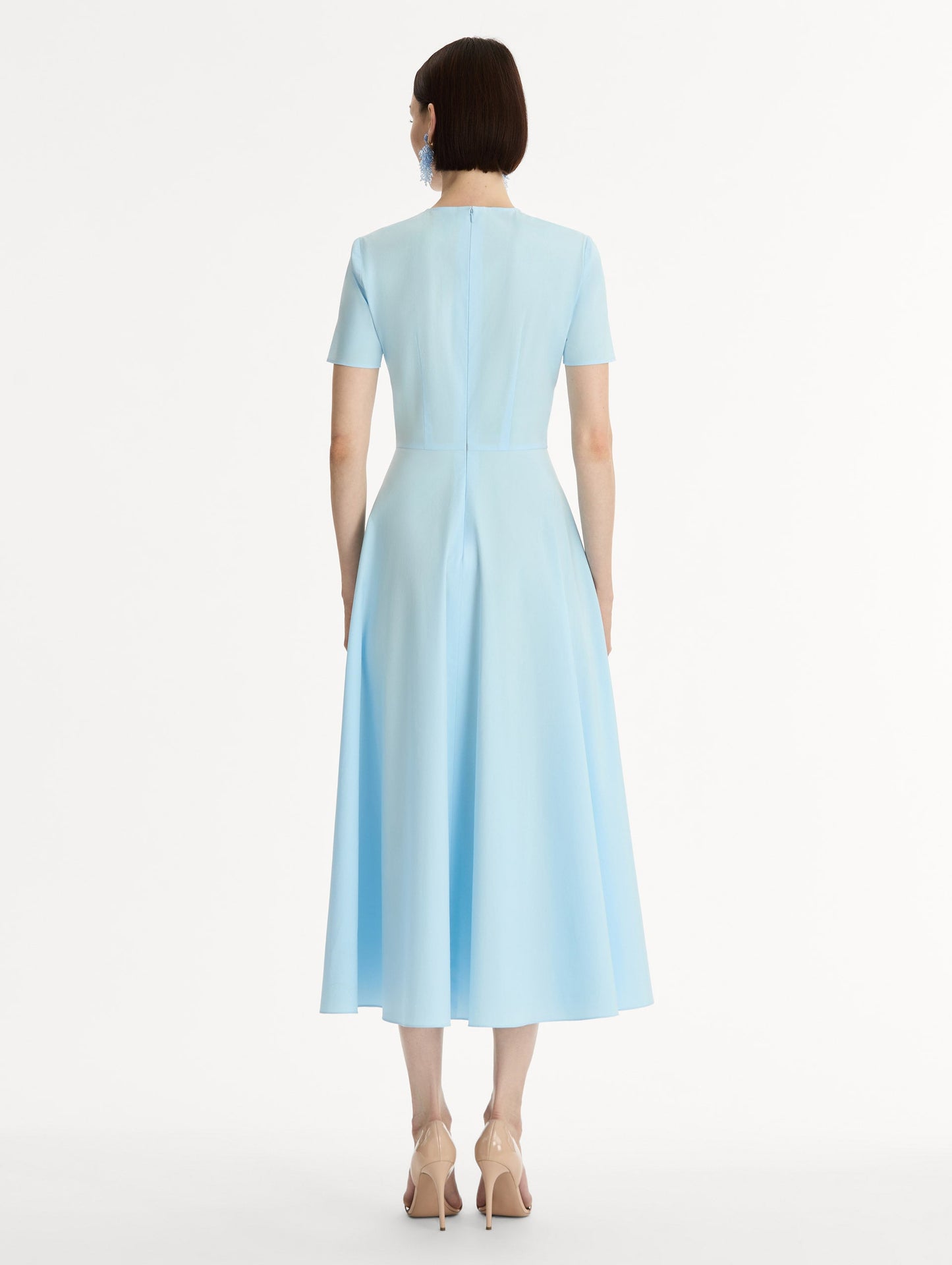 Short sleeve, light blue cotton poplin midi dress. Fitted bodice, full A-line skirt. Chiné Cyclamen motif with blurred, edges. Back View.
